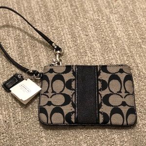 Coach wristlet in signature canvas